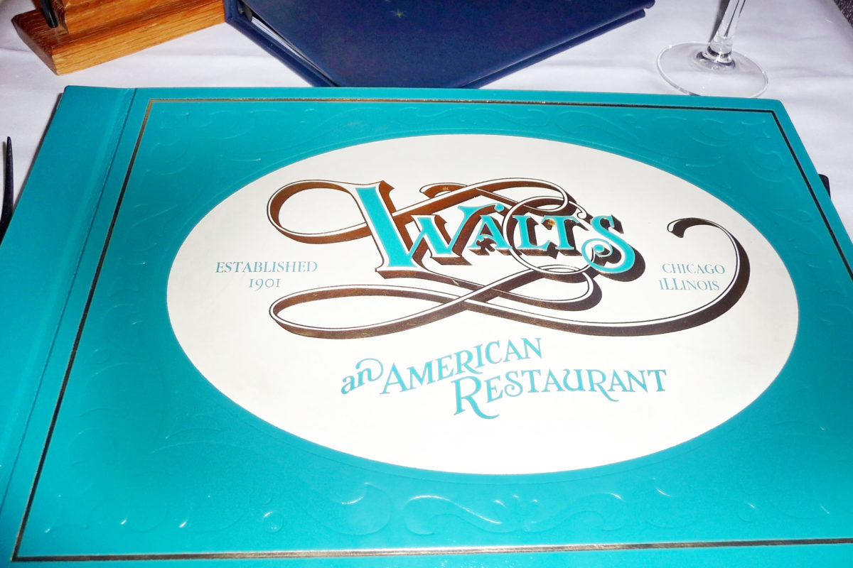 Image shows the front cover of the menu of Walt's, and American restaurant, in Disneyland paris.