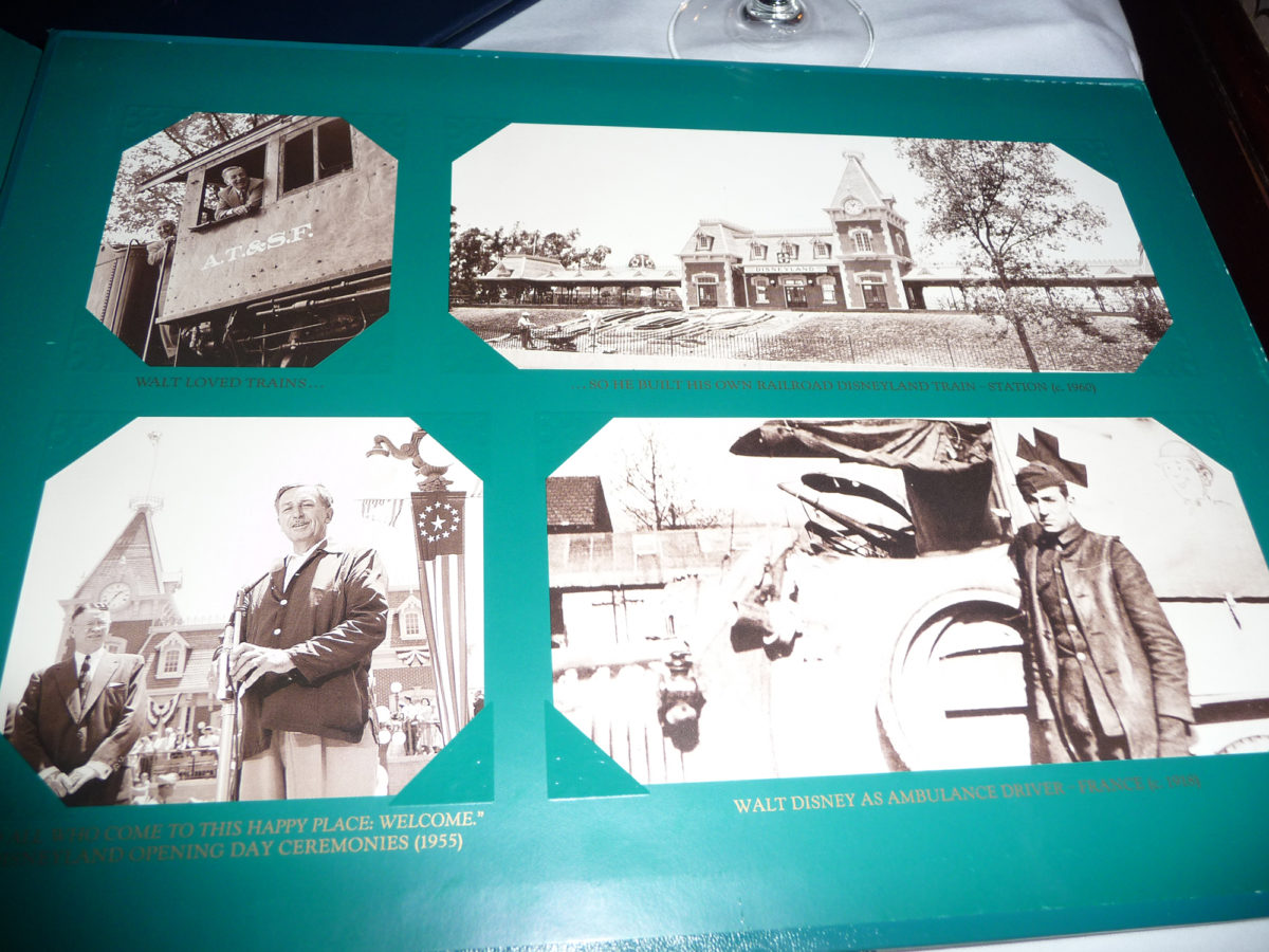 Image shows the inside of the menu at walt's restaurant in disneyland paris. There are various photographs of disney days gone by.
