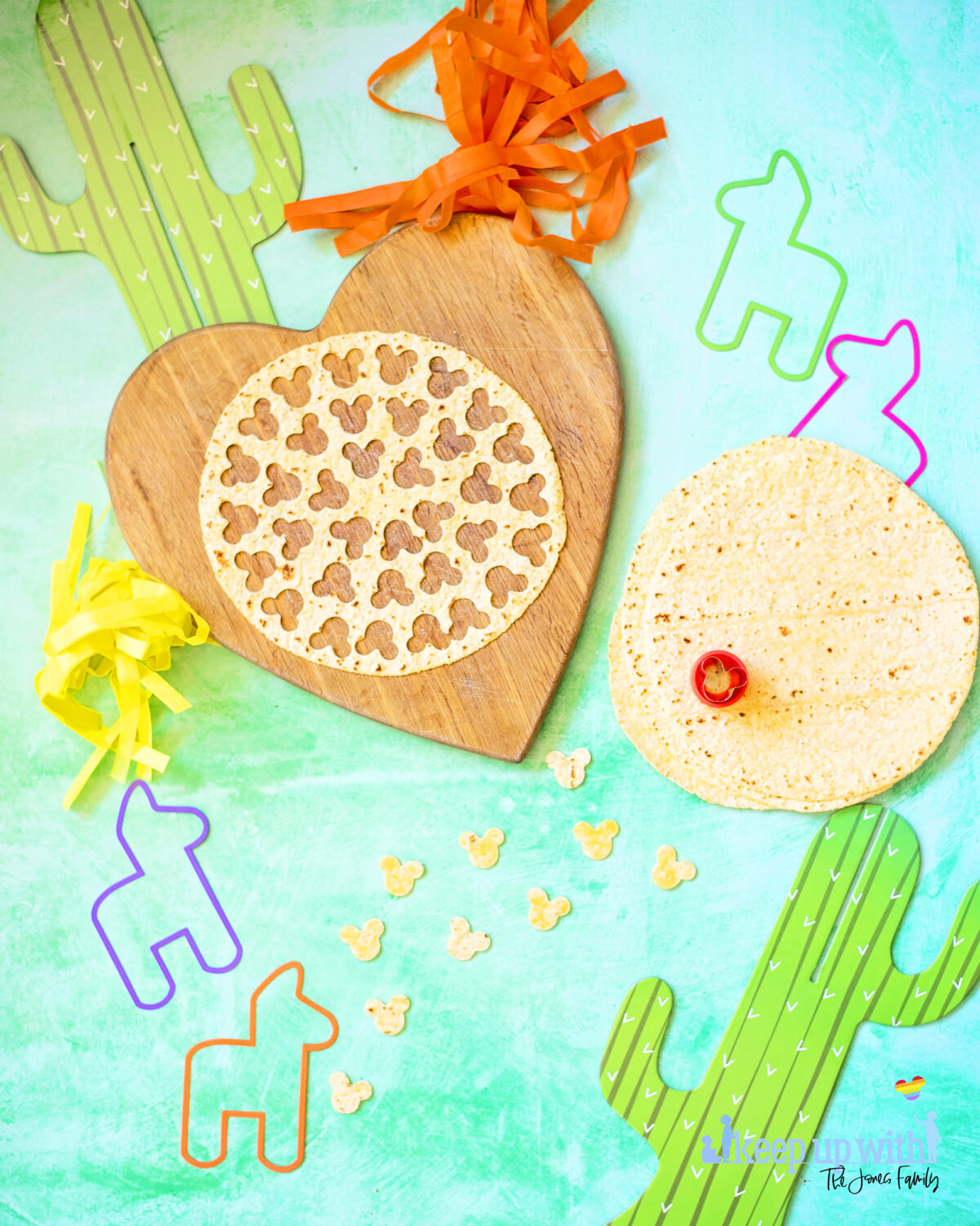 Image shows how to cut nacho chips from a tortilla. There are colourful llama cut outs and cardboard cacti, and a tortilla wrap which has been cut into little Mickey Mouse shaped pieces.  Keep up with the jones family