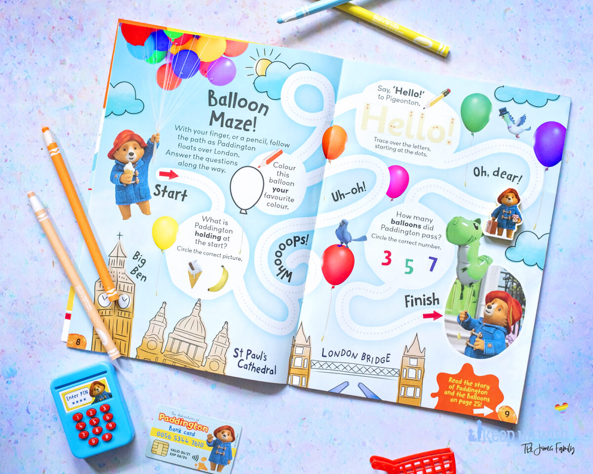 The Adventures of Paddington Bear Magazine EYFS. Photograph shows a two page spread featuring a balloon maze with paddington and his free shopping gift which comes with issue one.  Fun learning for children and early years foundation stage goals.