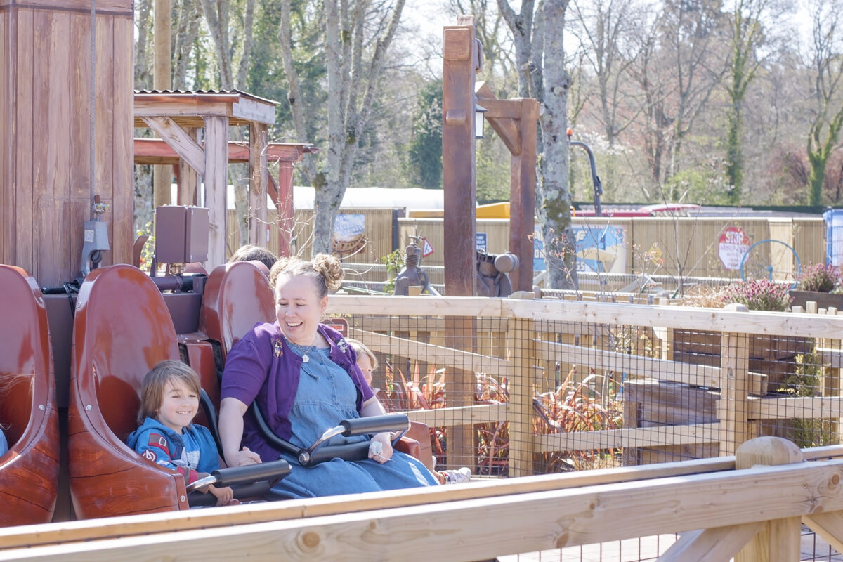 Image shows a mother and son seated on the Windmill Falls ride at Tornado Springs, Paultons Park, Hampshire.