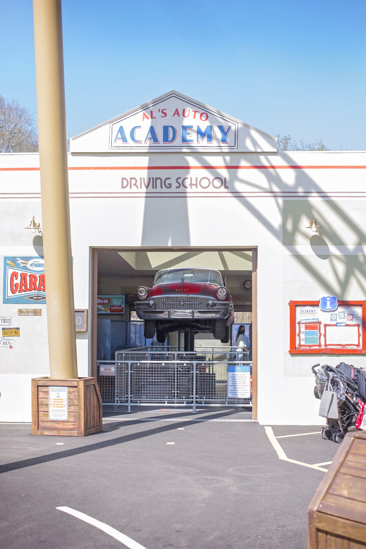 Image shows the open queue area and elevated 1950s car at  Al's Auto Academy Driving School at Tornado Springs in Paultons Park.