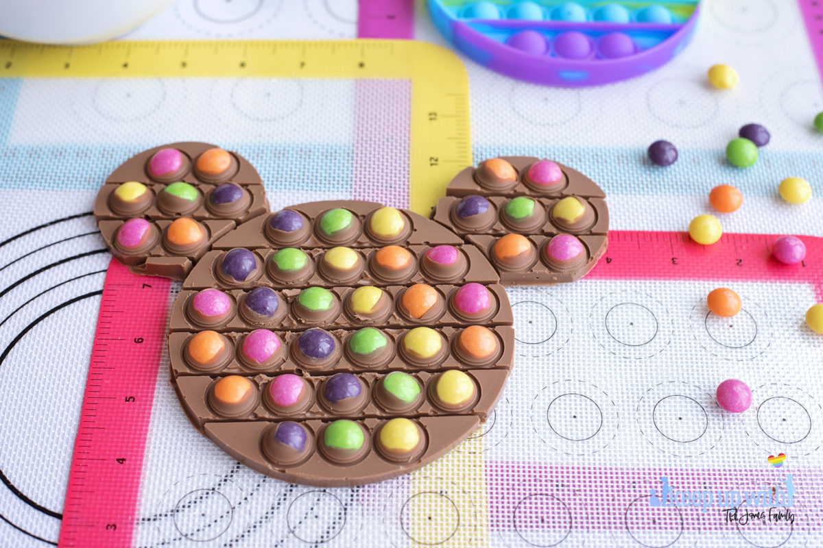 Image shows a mickey mouse chocolate pop-it bar filled with dairy milk and skittles candy sweets. Image by keep up with the jones family.