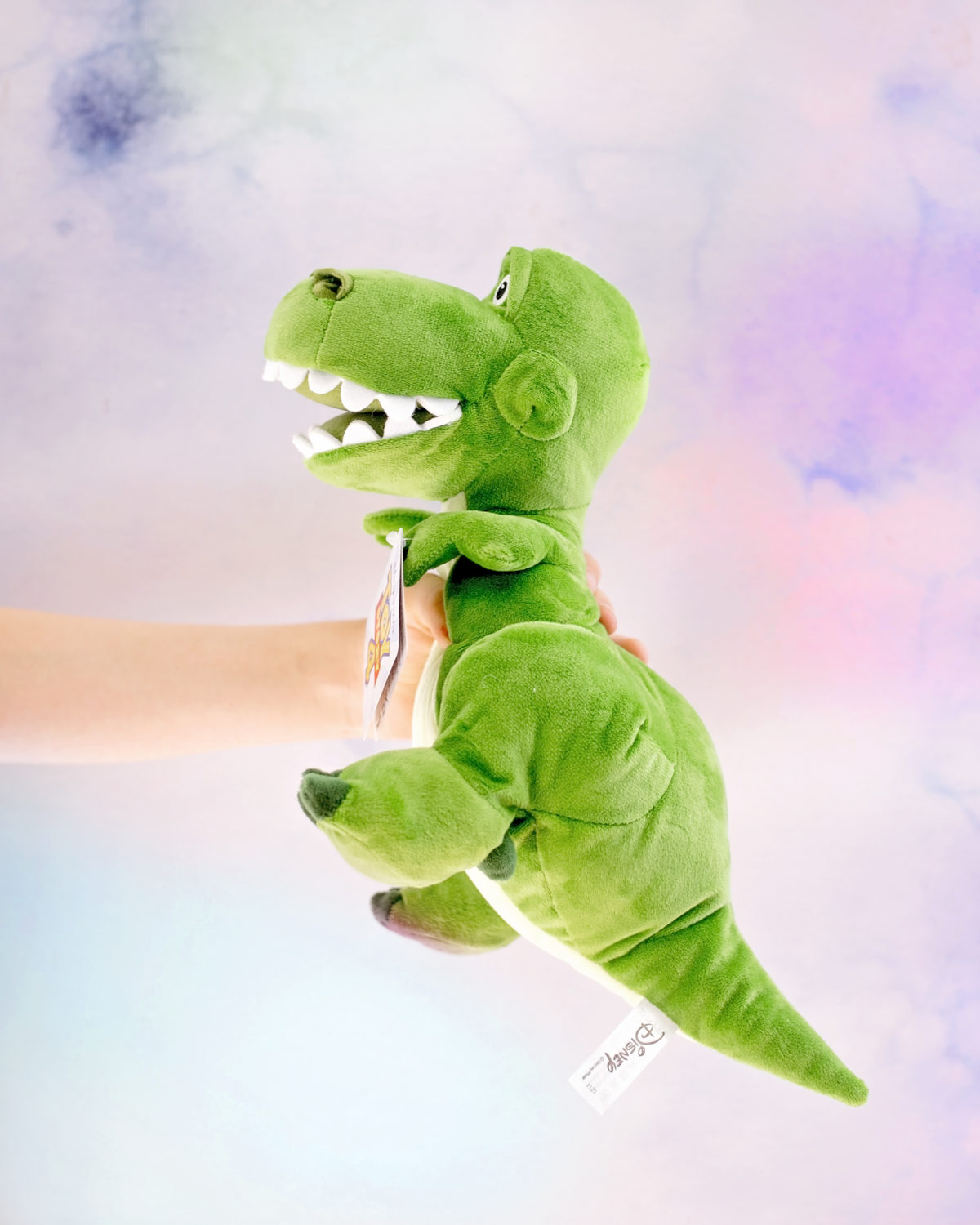 Image shows profile view of Disney Pixar's Toy Story Dinosaur, Rex as a plush toy from SImba Toys. Image by Keep Up With The Jones Family. 