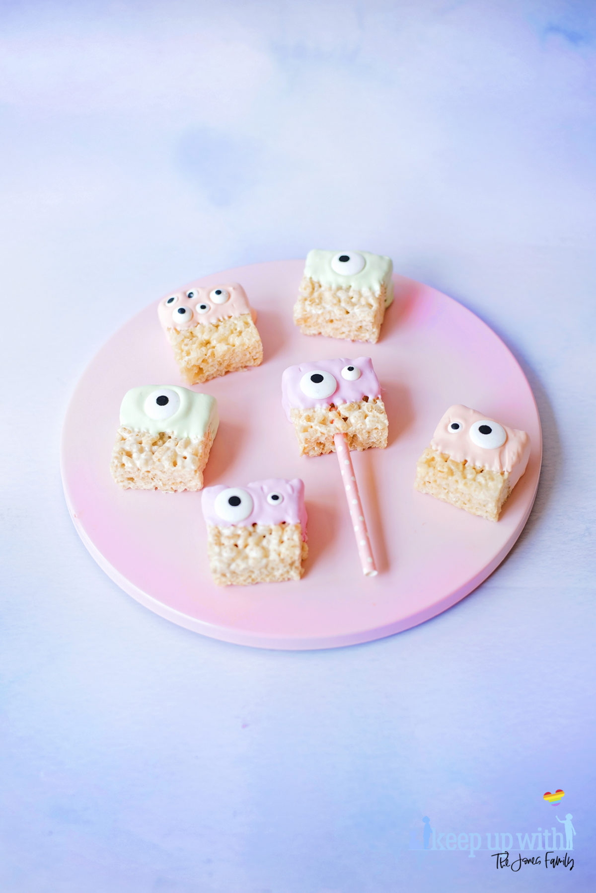 Image shows a pink cake plate with a variety of candy dipped pastel coloured alien rice krispie monsters. Image by Sara-Jayne for Keep Up With The Jones Family.